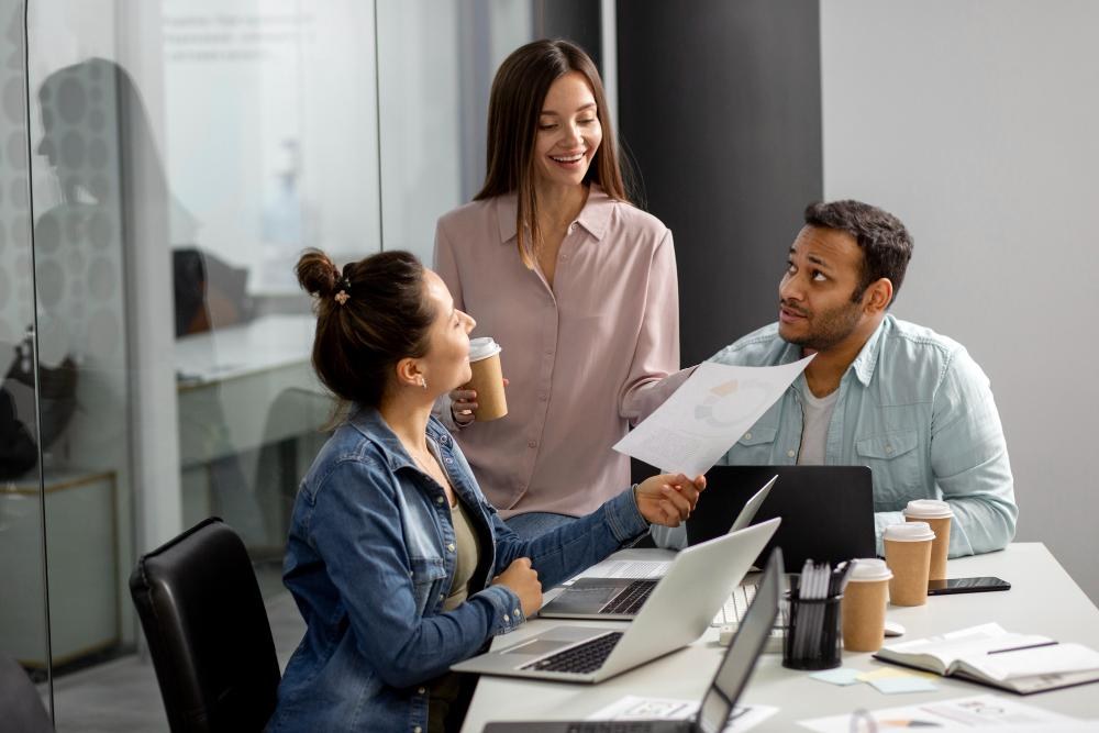 Small-business colleagues planning together with laptops and a tablet