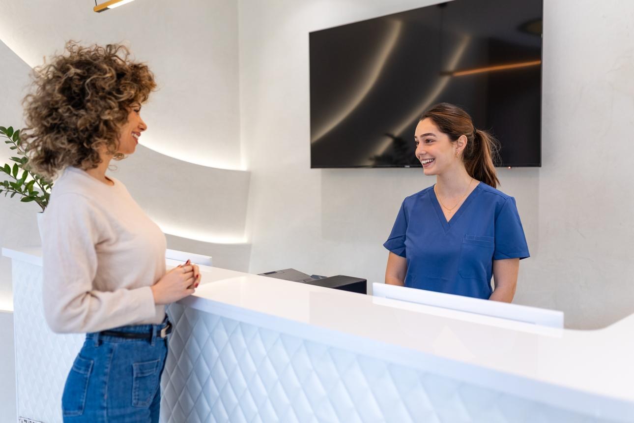 A wellness-practice team member welcoming a visitor at reception