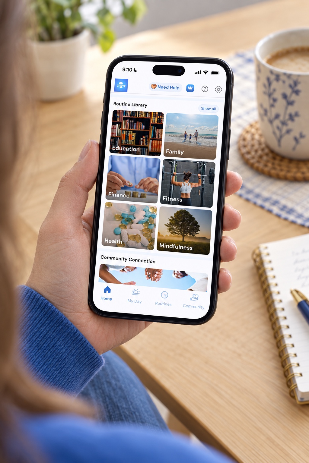 Close-up of a person holding a phone displaying the Lightbridge Life Routine Library at home